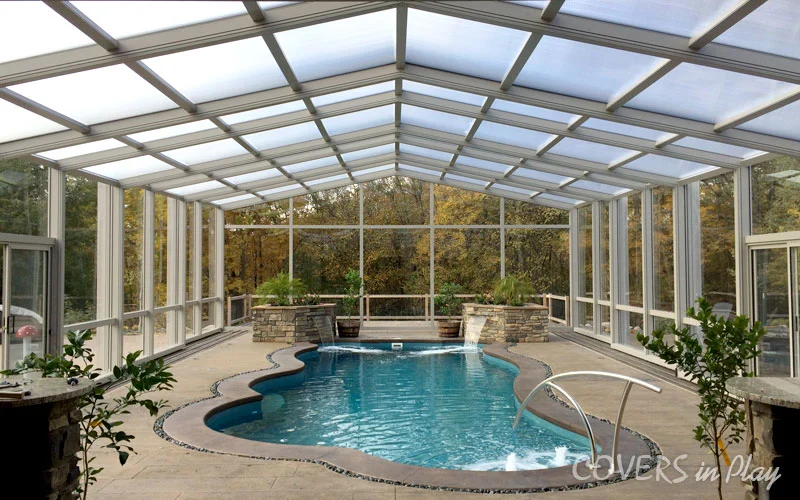 Interior view of residential pool dome enclosure with waterfalls in Des Moines