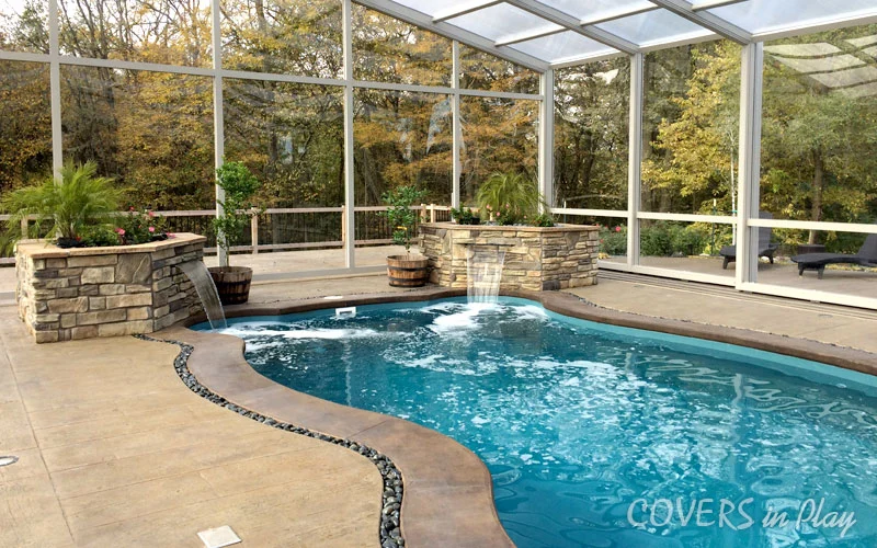 Close-up view of pool dome enclosure with built in waterfall features in Des Moines, IA